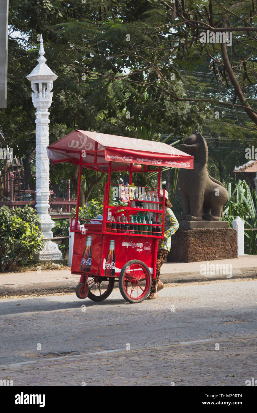 street vendor / man with old coca cola cart sells drinks on street Stock Photo