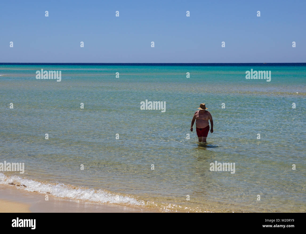 Fuerteventura , Spain 13 june 2017 : an overweight man takes a bath in the sea. Poor nutrition and a sedentary lifestyle. Increased risk of heart disease. Stock Photo