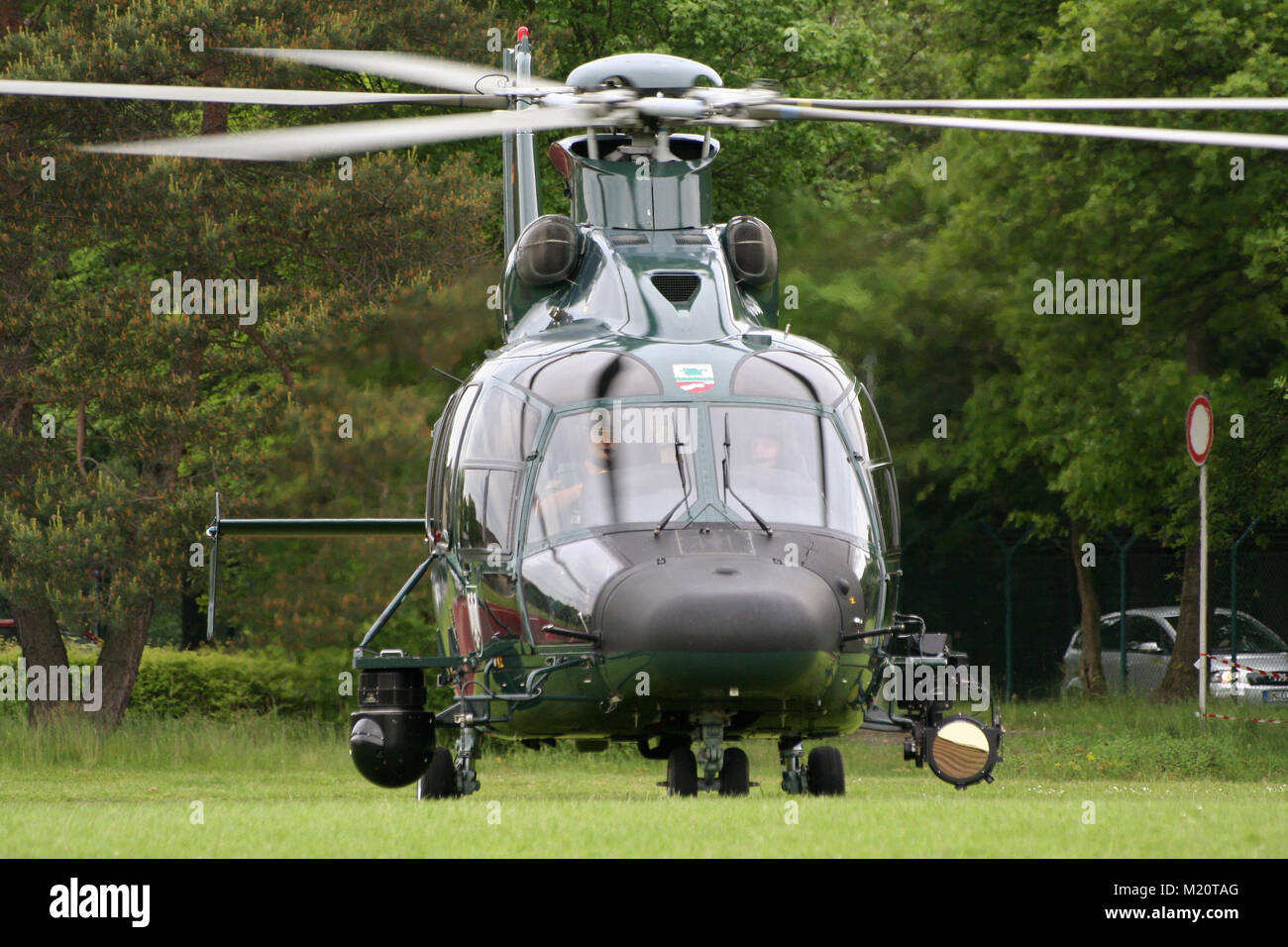 BONN, GERMANY - MAY 22, 2010: German Border patrol EC-155 helicopter of the Bundesgrenzschutz taking off from a grass field at Bonn-Hangelar airport. Stock Photo