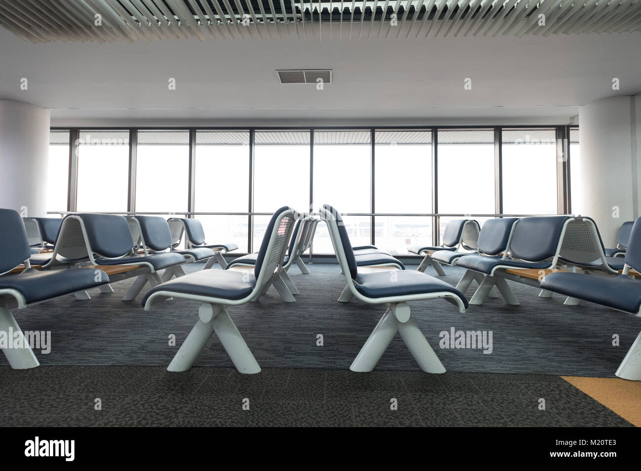 Empty airport terminal waiting area with chairs lounge with seats in the airport Stock Photo