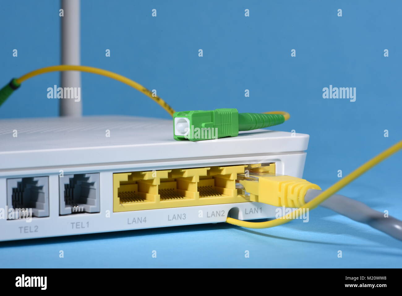 Wireless router with network patch cord and optical cable Stock Photo -  Alamy