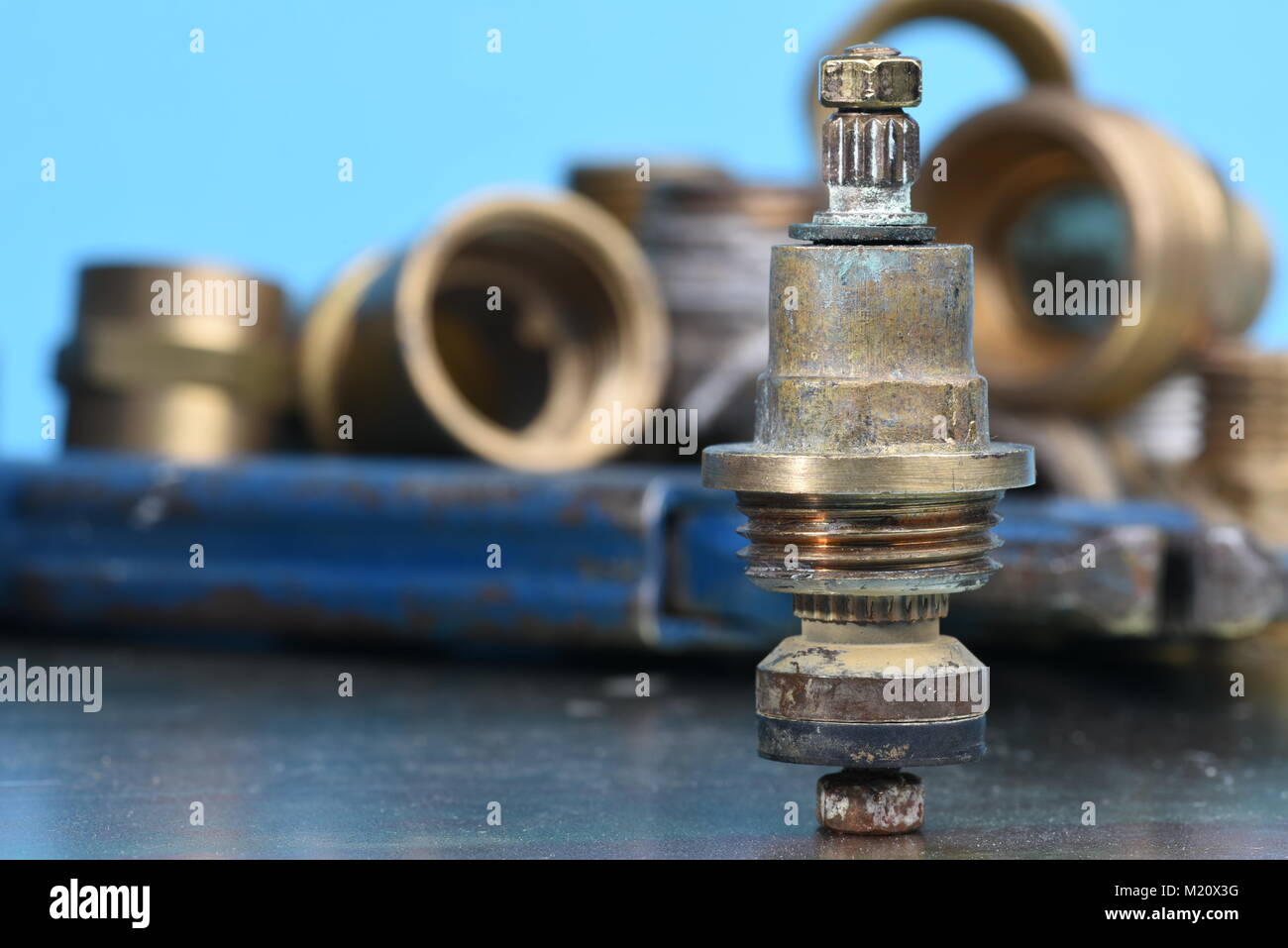 Plumbing Parts and Repair Old brass Tap Valve and Tools Stock Photo