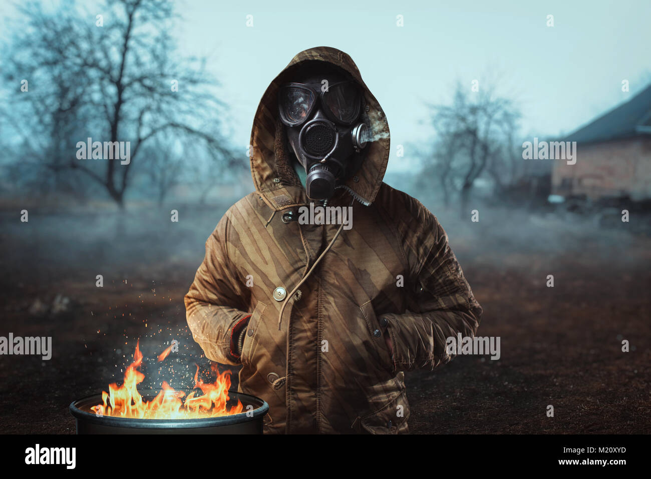 Stalker soldier in gas mask against fire, survivor man after nuclear ...