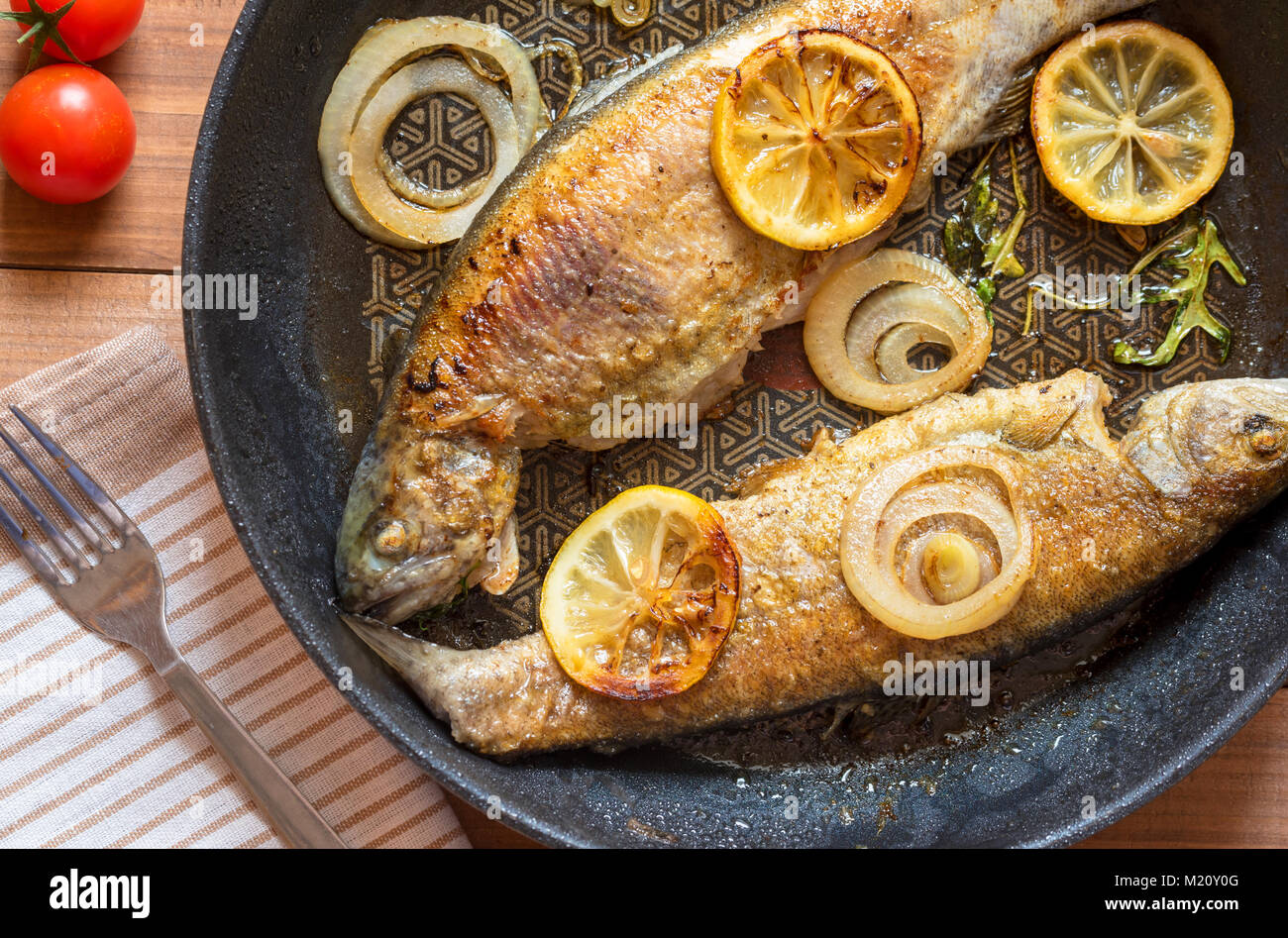 Fried trout fish on frying pan Stock Photo Alamy