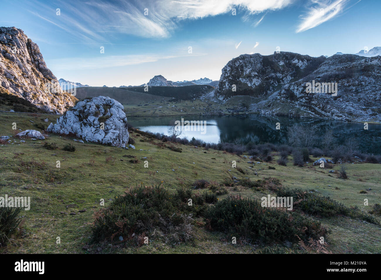 spectacular and colorful sunset in the lakes of Covadonga, Asturias, on a very cold winter day, where you can see the beautiful colors of the clouds, Stock Photo