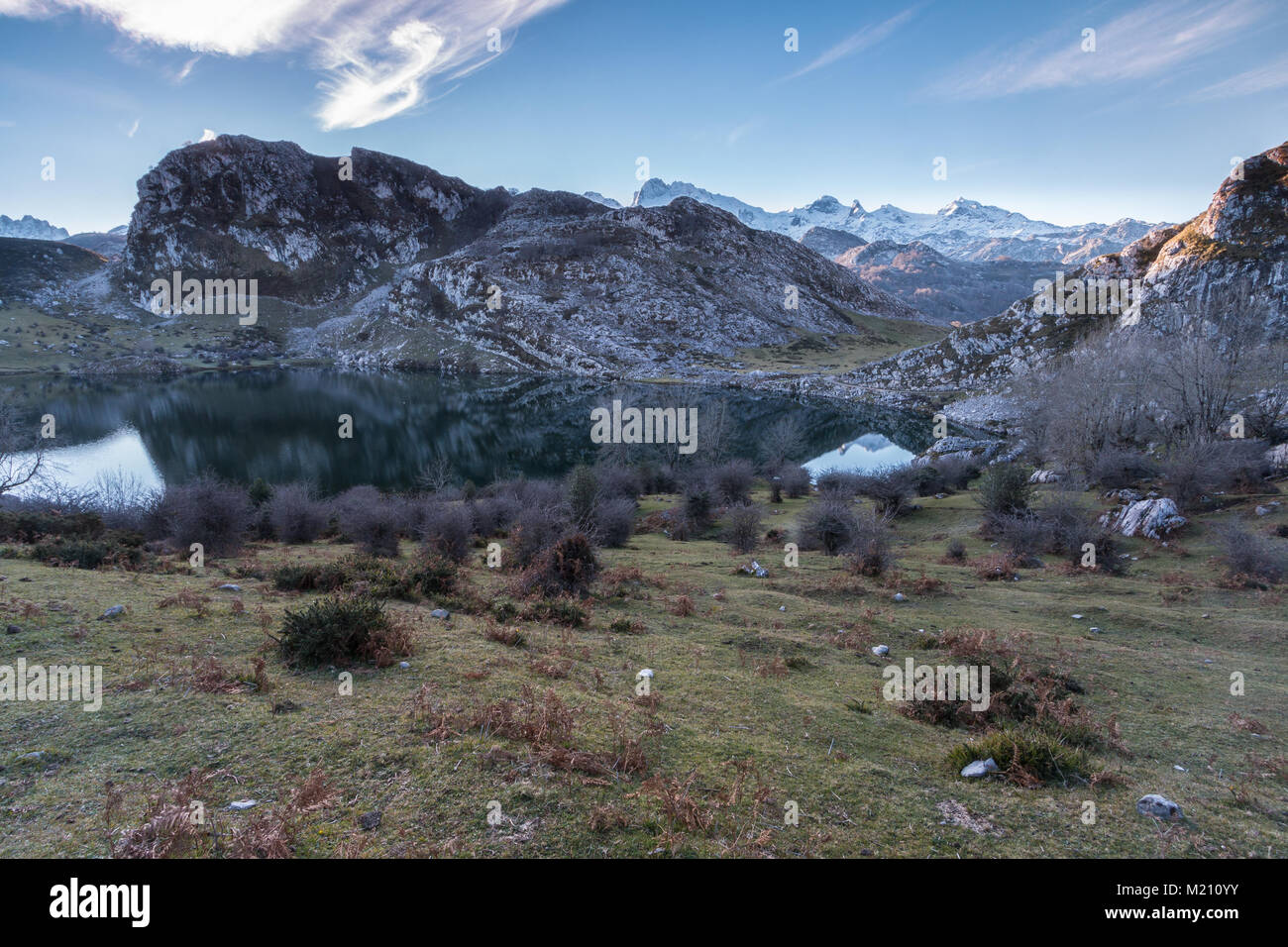 spectacular and colorful sunset in the lakes of Covadonga, Asturias, on a very cold winter day, where you can see the beautiful colors of the clouds, Stock Photo