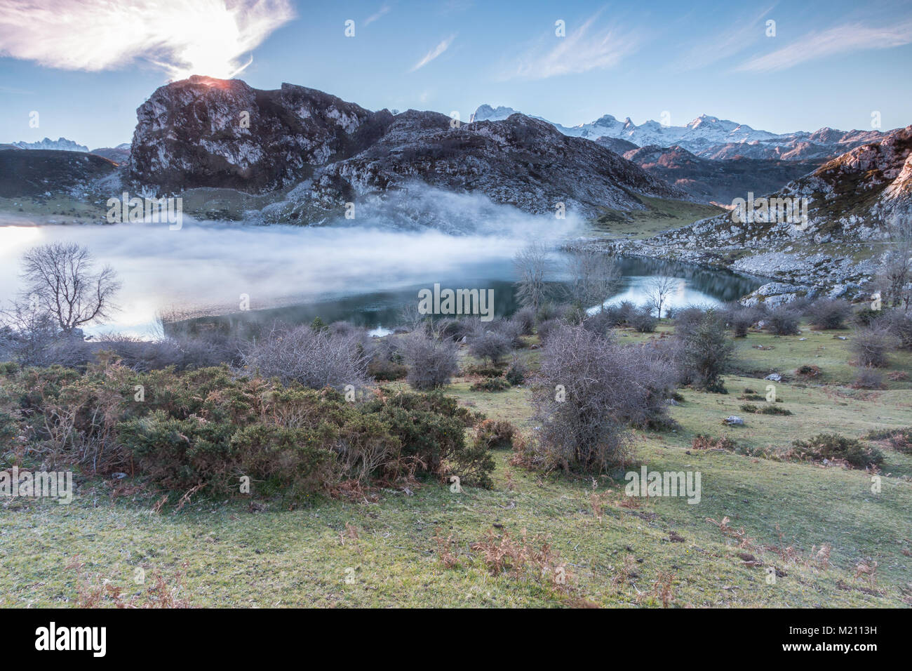 spectacular and colorful sunset in the lakes of Covadonga, Asturias, on a very cold winter day, where you can see the beautiful colors of the clouds, Stock Photo