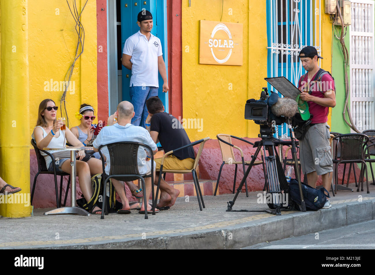 Cartagena, Colombia - January 23th, 2018: A cameraman reading a menu at the Solar Bar, colonial style in the Calle de San Antonio at Getsemani distric Stock Photo