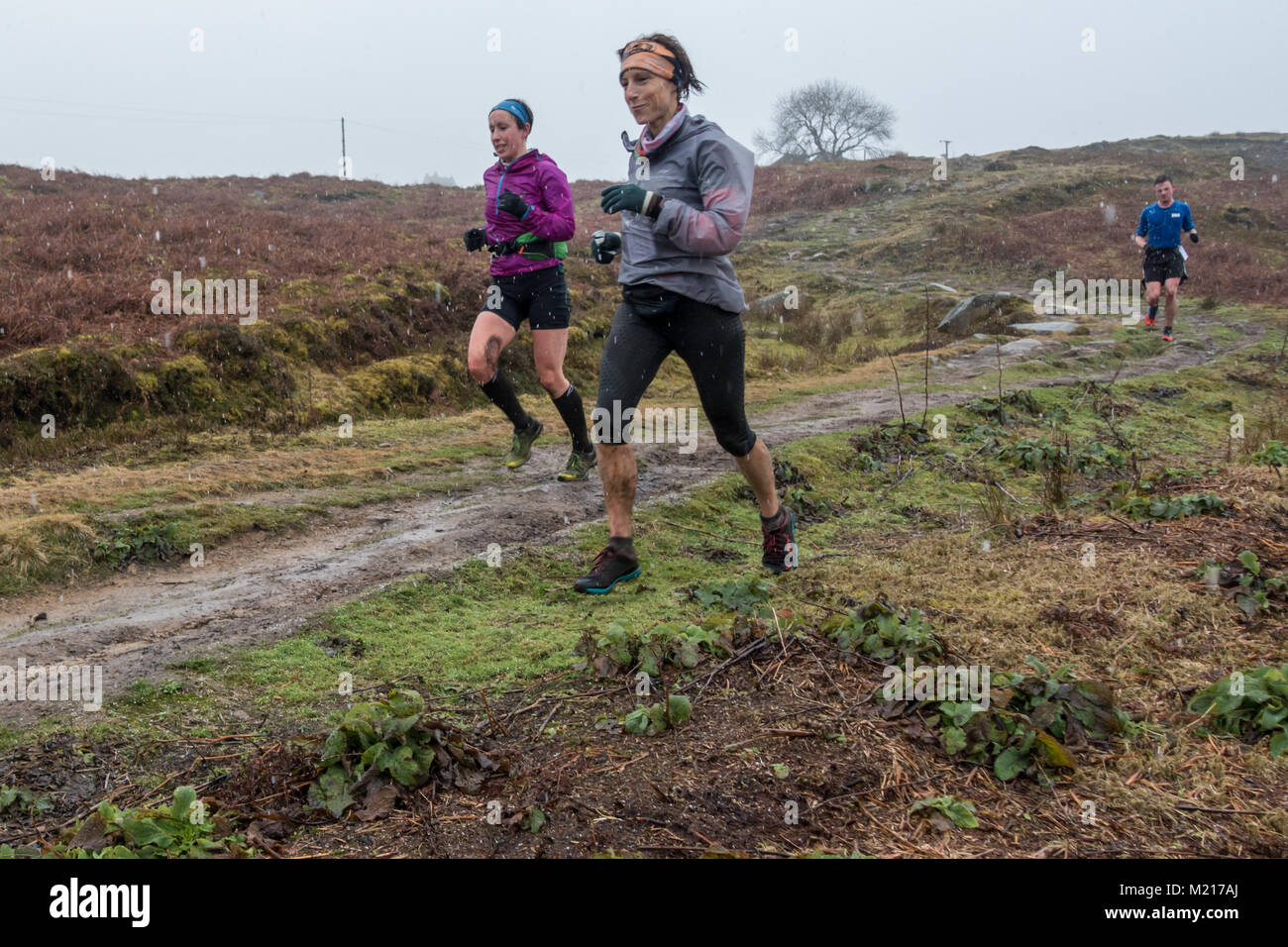 Burley Woodhead, West Yorkshire, UK. 3rd February 2018.  Two female runners (LHS Rachel Pilling) enjoying the Rombalds Stride Winter Challenge 2018 and fell race in the snow.  Rebecca Cole/Alamy Live News Stock Photo