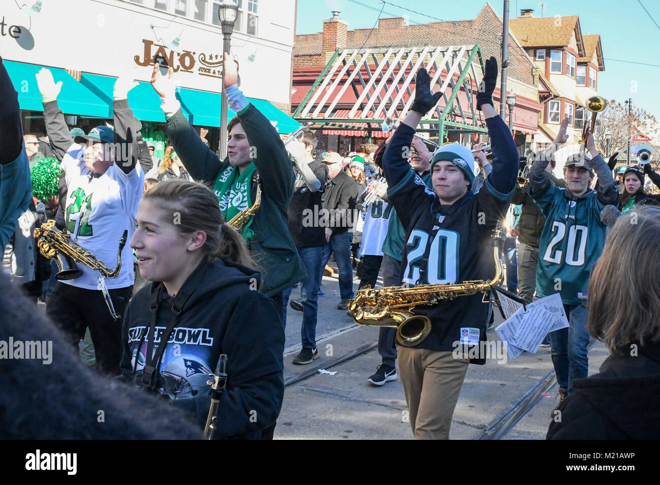 Media, PA, USA, The Penncrest High School marching band entertains thousands of Philadelphia Eagles fans as they line the streets of Media for a pep rally supporting the NFC Championship Philadelphia Eagles in their pursuit of winning the NFL Super Bowl. Media, Delaware County, PA is located approximately 14 miles South of Philadelphia, PA. Temperatures in the mid 20 degree range (fahrenheit) Credit: Don Mennig/Alamy Live News Stock Photo