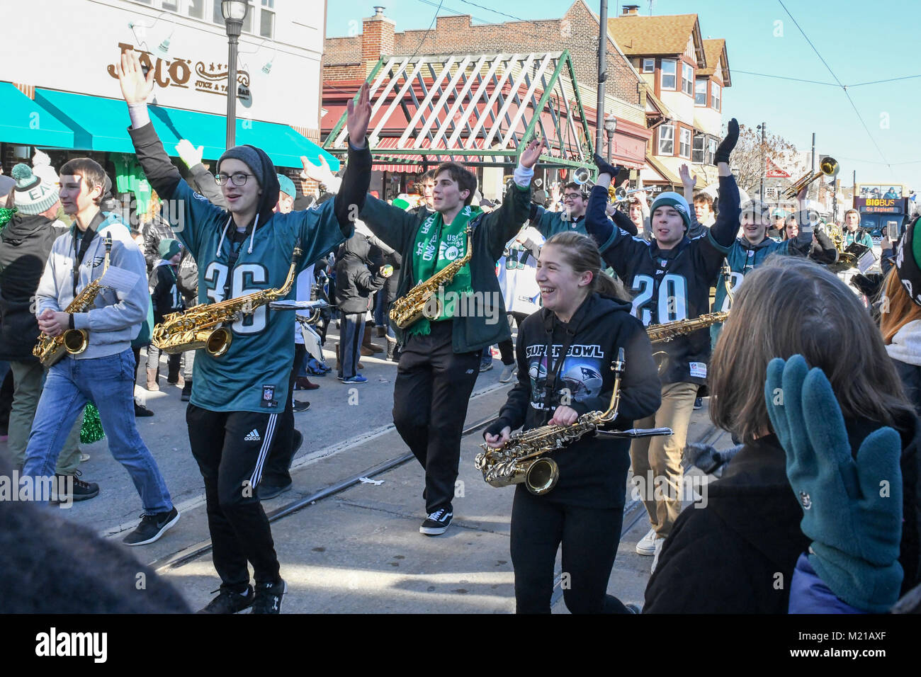 Media, PA, USA, The Penncrest High School marching band entertains thousands of Philadelphia Eagles fans as they line the streets of Media for a pep rally supporting the NFC Championship Philadelphia Eagles in their pursuit of winning the NFL Super Bowl. Media, Delaware County, PA is located approximately 14 miles South of Philadelphia, PA. Temperatures in the mid 20 degree range (fahrenheit) Credit: Don Mennig/Alamy Live News Stock Photo