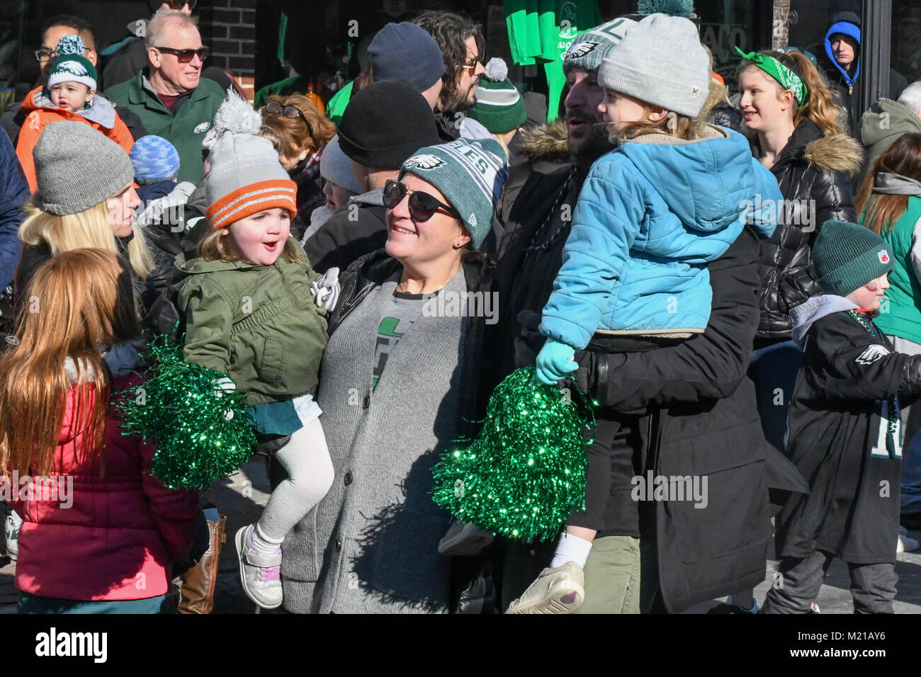 Media, PA, USA, Girl toddlers with sparkling green pom poms / pompoms / pom-poms and thousands of Philadelphia Eagles fans line the streets of Media for a rally supporting the NFC Championship Philadelphia Eagles in their pursuit of winning the NFL Super Bowl. Media, Delaware County, PA is located approximately 14 miles South of Philadelphia, PA. Temperatures in the mid 20 degree range (fahrenheit) Credit: Don Mennig/Alamy Live News Stock Photo