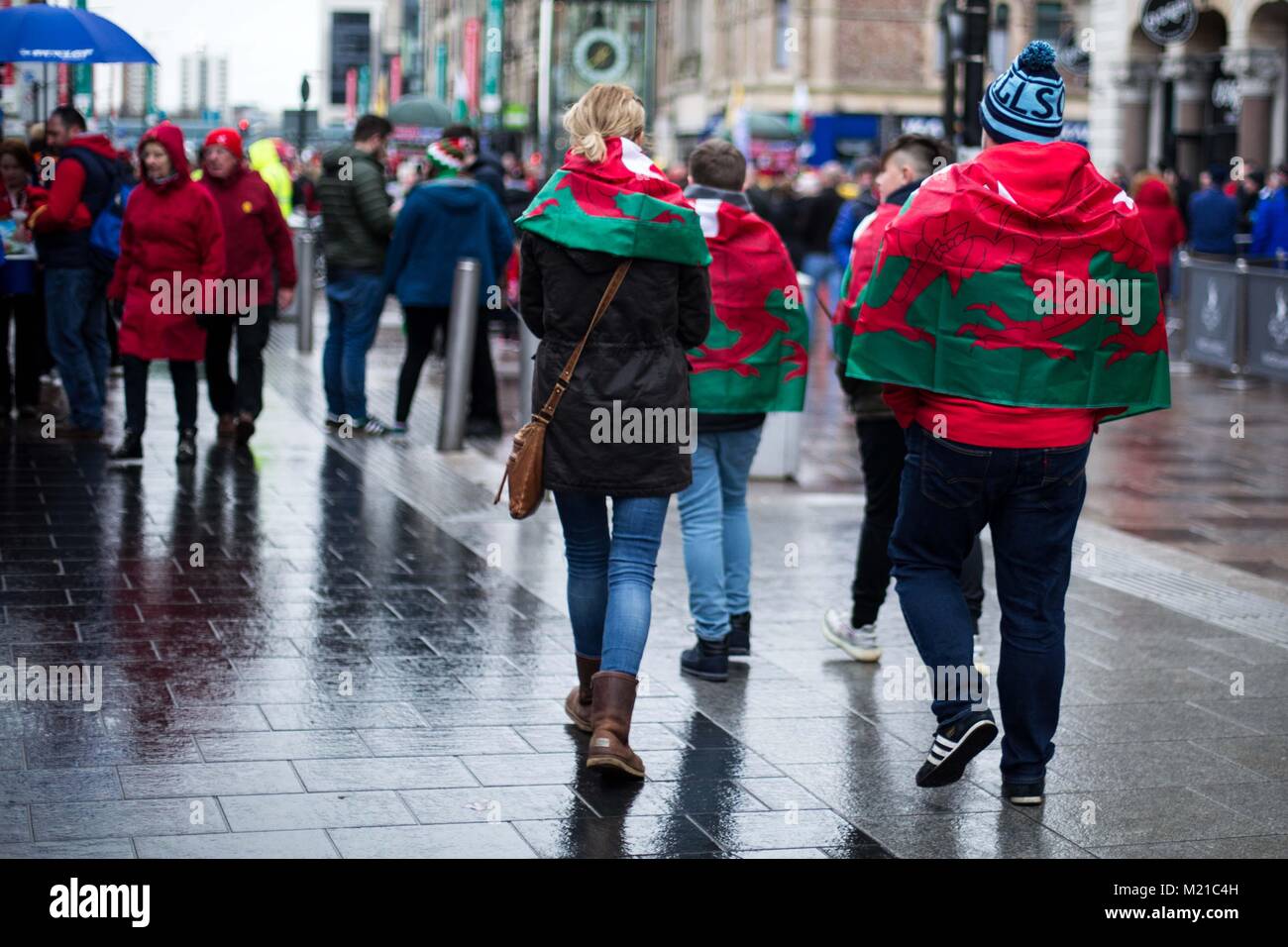 UNITED KINGDOM, WALES. 03 February 2018. Welsh fans make their way to the Stadium in the rain. Credit: Lorna Cabble/Alamy Live News Stock Photo