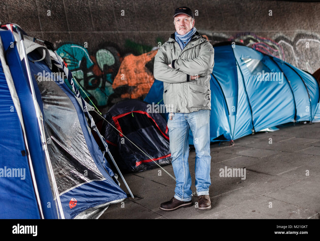 The formerly homeless Joerg Petersen, standing at a homeless camp under the Lombard Bridge by the river Alster in Hamburg, Germany, 01 Febuary 2018. Petersen collected 80000 signatures with an online petition for the opening of emergency winter programmes for the homeless during the daytime. Photo: Markus Scholz/dpa Stock Photo