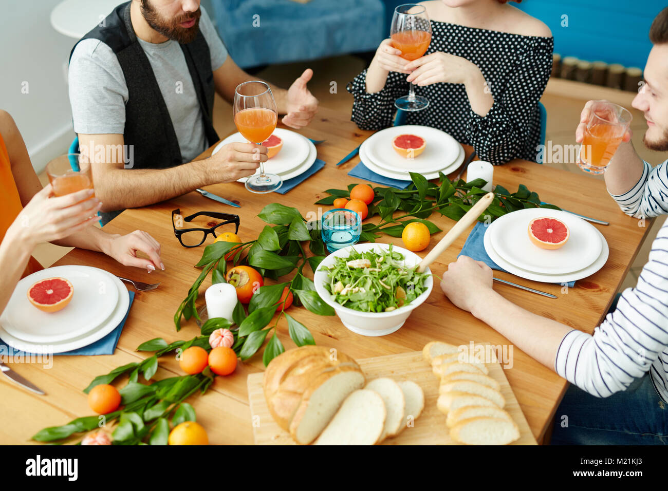 Friends by table Stock Photo - Alamy