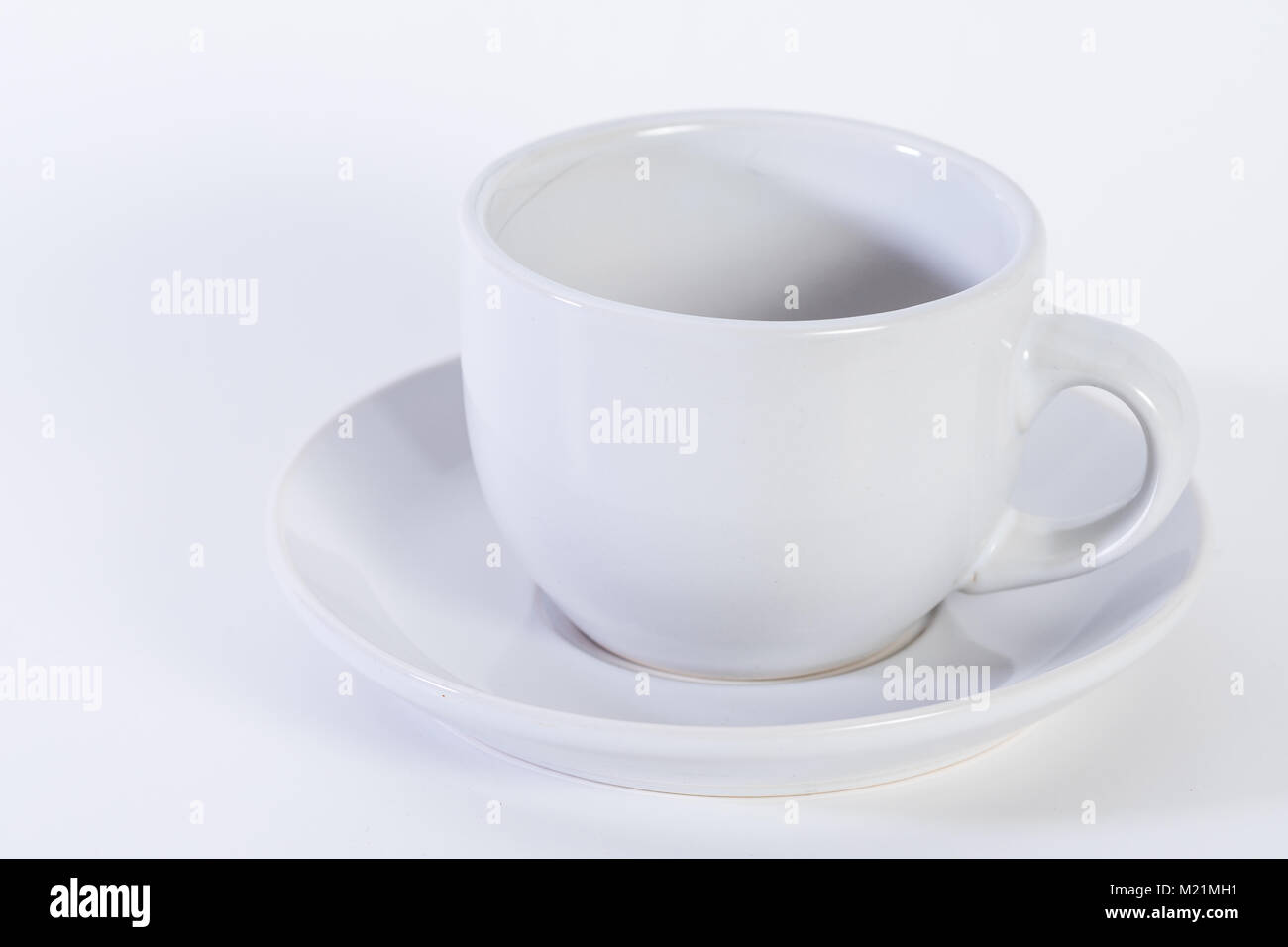 Coffee beans in a coffee or espresso cup, plain white background Stock Photo
