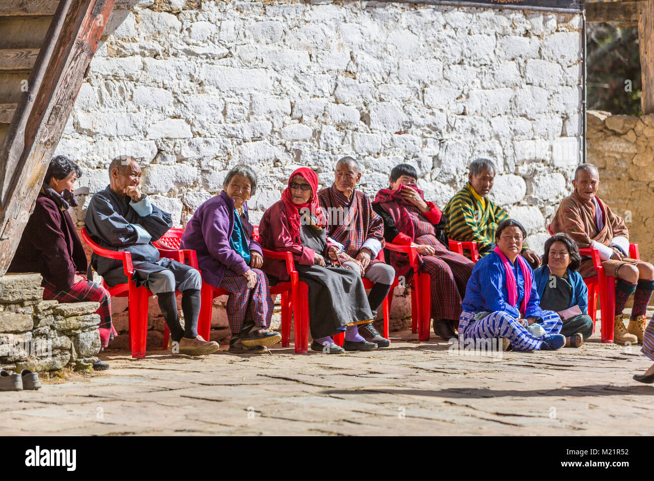 Prakhar Lhakhang, Bumthang, Bhutan.  Bhutanese Adults Waiting for a Religious Performnance to Begin. Stock Photo