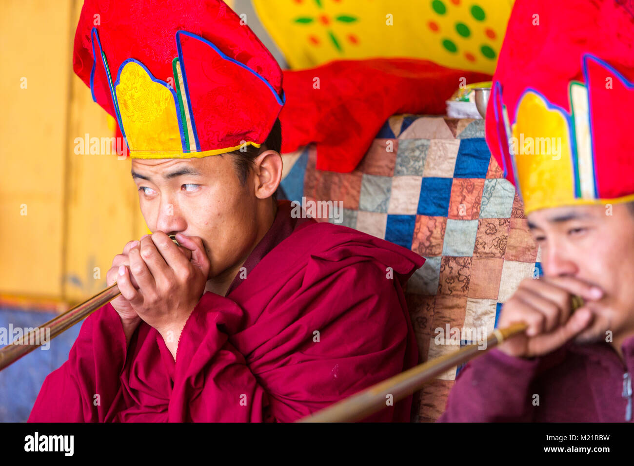 Prakhar Lhakhang, Bumthang, Bhutan.  Two Buddhist Monks Playing Dungchen, the Long Tibetan Trumpet. Stock Photo