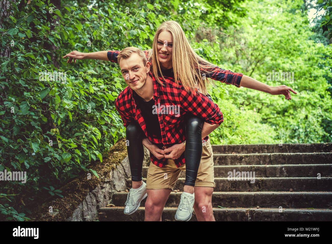 Loving couple having fun in a wild summer park. Stock Photo