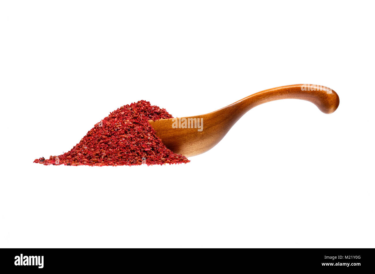 Sumac in the wooden spoon, isolated on white background. Stock Photo