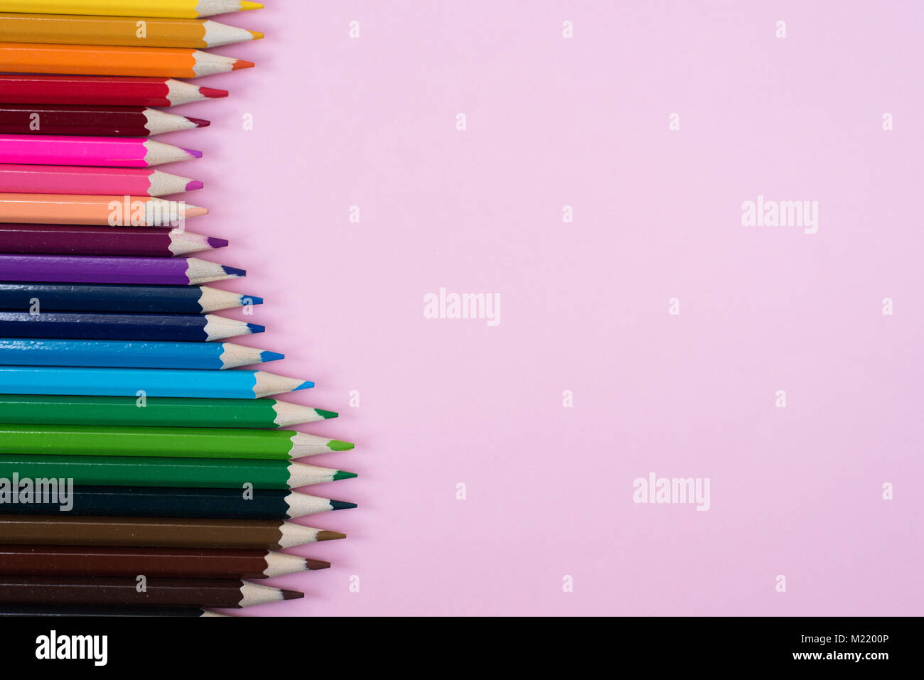 Colored pencils isolated on pink background. group of colored pencil