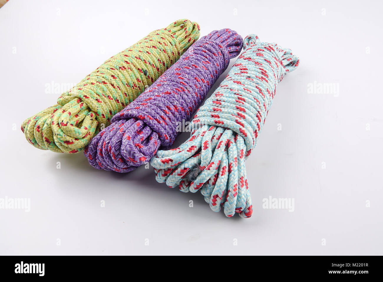 Various colour of ropes isolated on white background Stock Photo - Alamy
