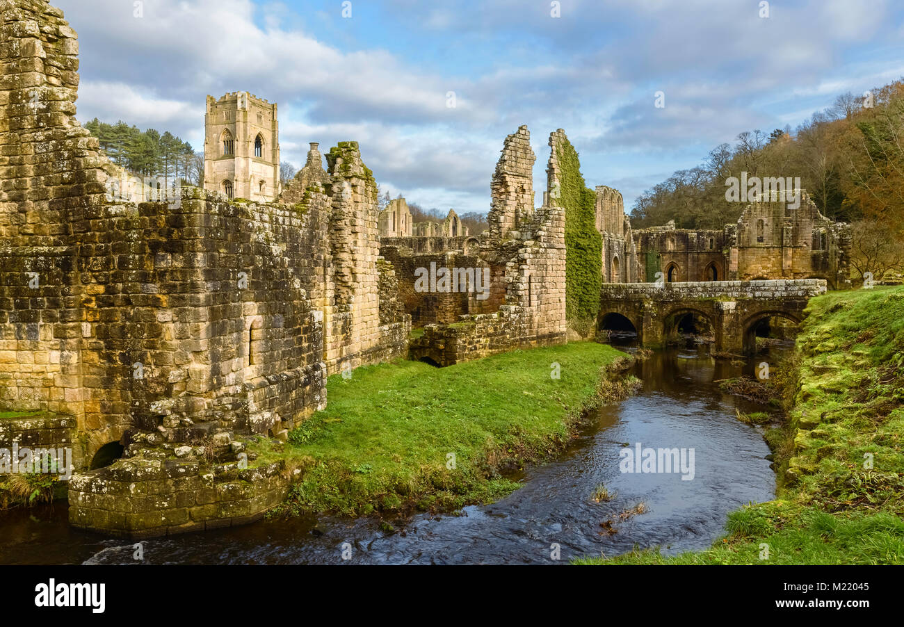 The ruins of Fountains Abbey on a fine autumn morning as viewed from across the river Skell near Ripon, Yorkshire, UK. Stock Photo