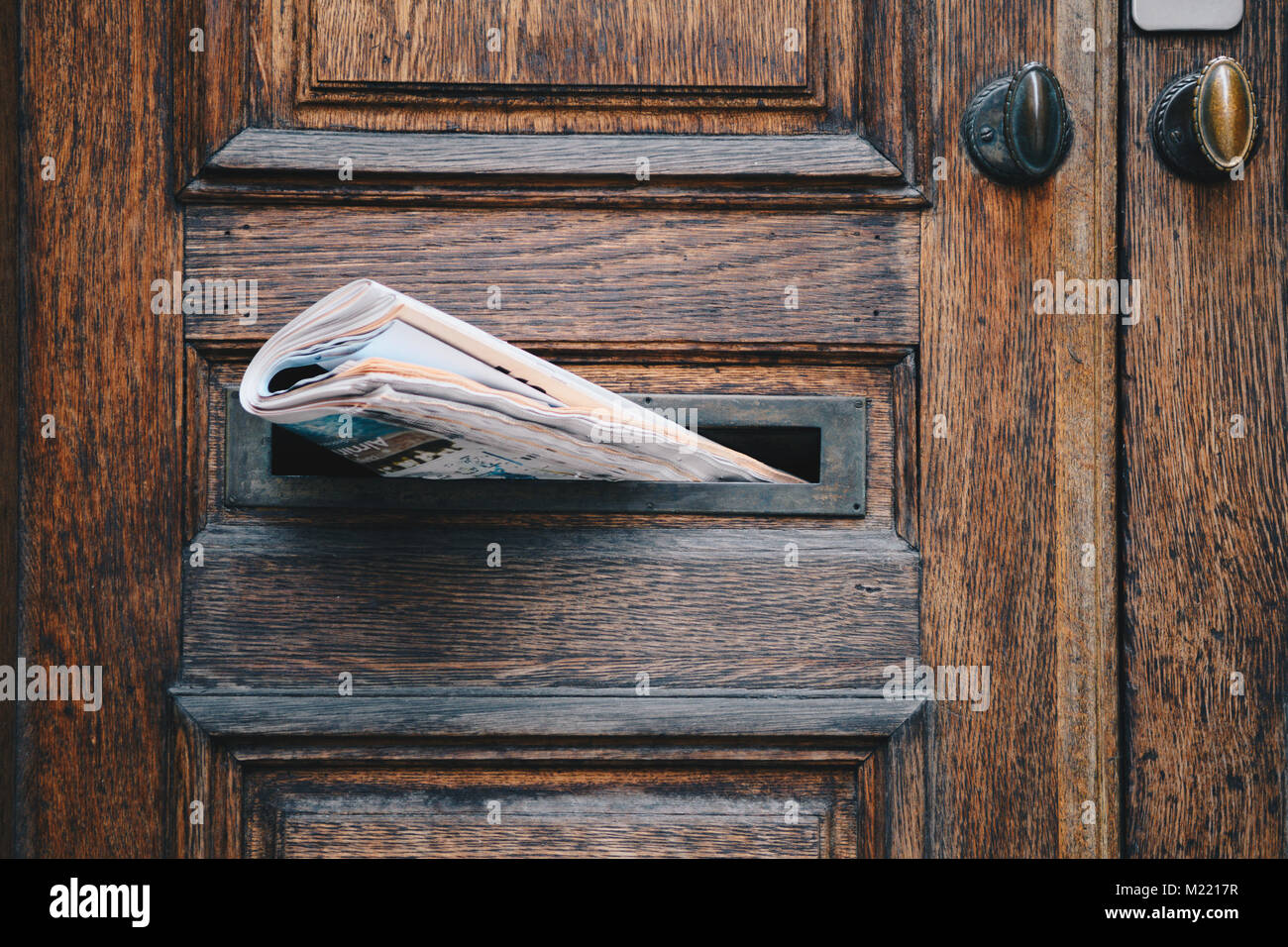 Morning newspaper delivered to door mail slot Stock Photo Alamy