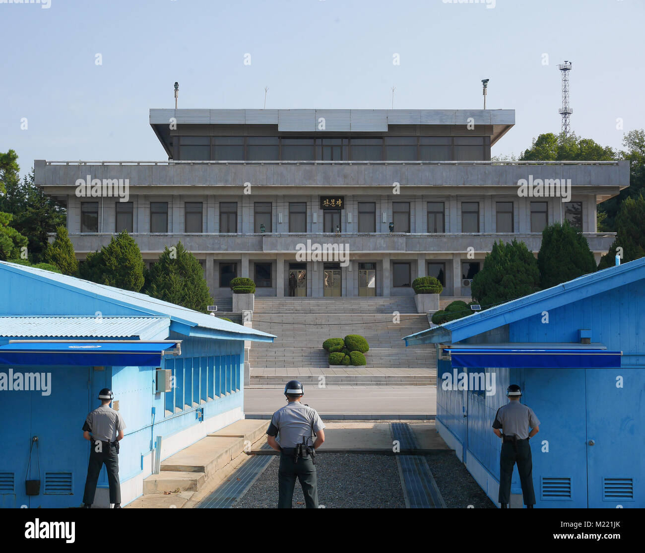 PANMUNJEON, SOUTH KOREA - SEPTEMBER 26, 2017: DMZ or DPRK demilitarized zone from South Korea facing North Korea, with South Korean soldiers looking t Stock Photo