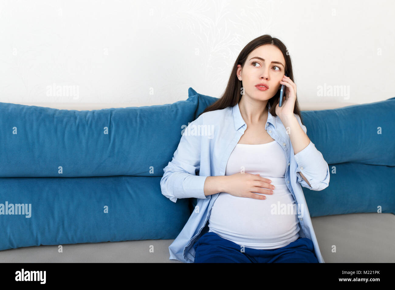 pregnant woman talking on phone Stock Photo
