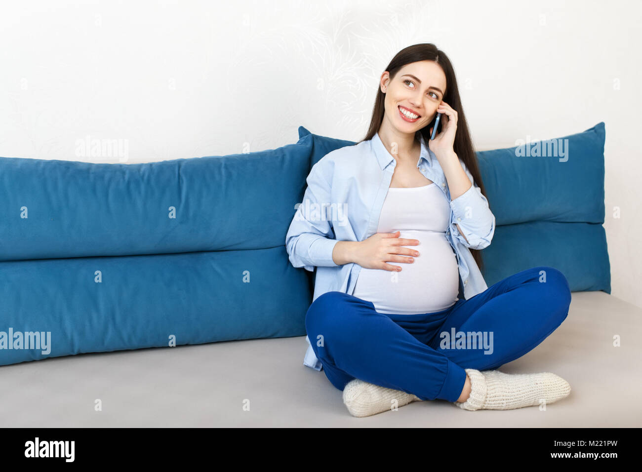pregnant woman talking on phone Stock Photo
