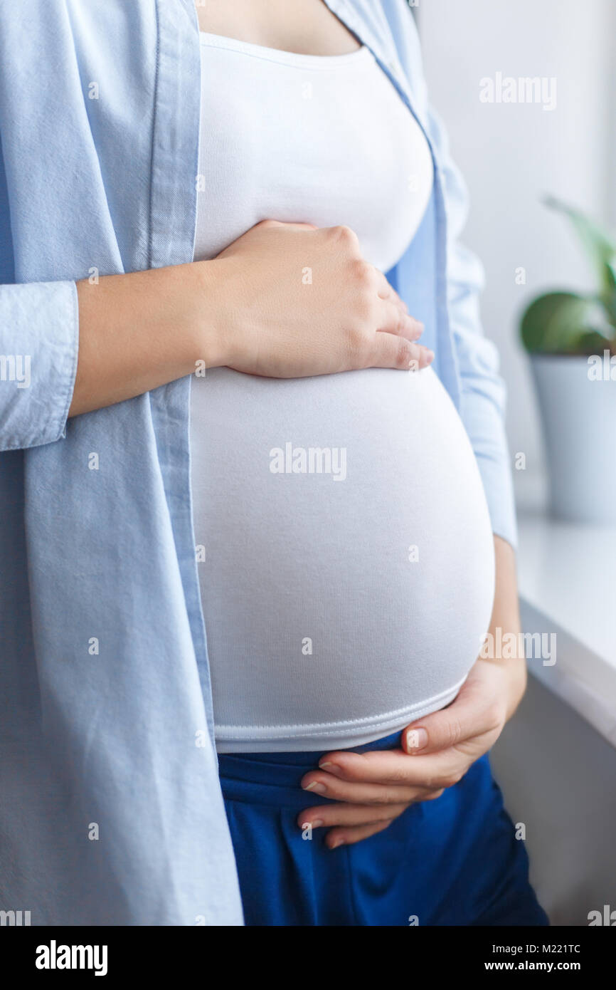 closeup pregnant woman touching her belly Stock Photo Alamy