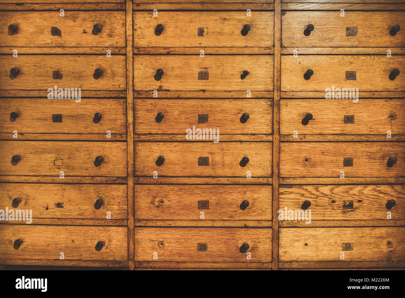 Old vintage wooden drawer organizer. Retro card file cabinet. Vintage filter applied Stock Photo