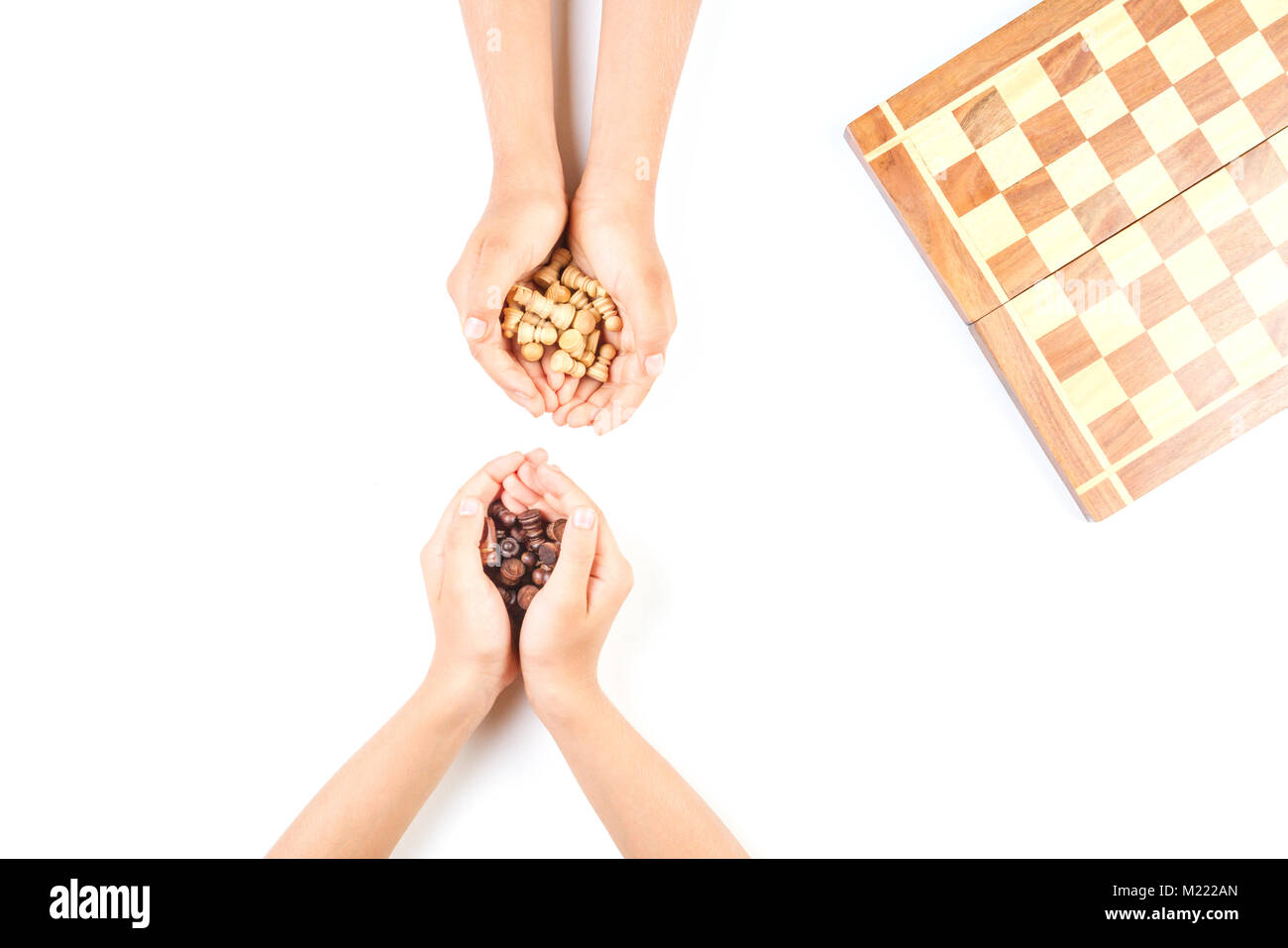Top view of kid hand and chess board with chess pieces Stock Photo