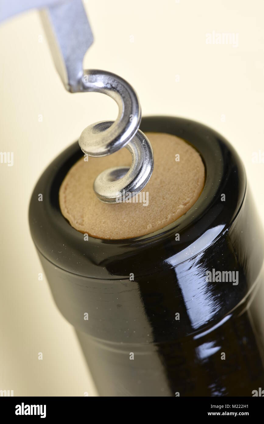 Close-up of opening bottle with corkscrew Stock Photo