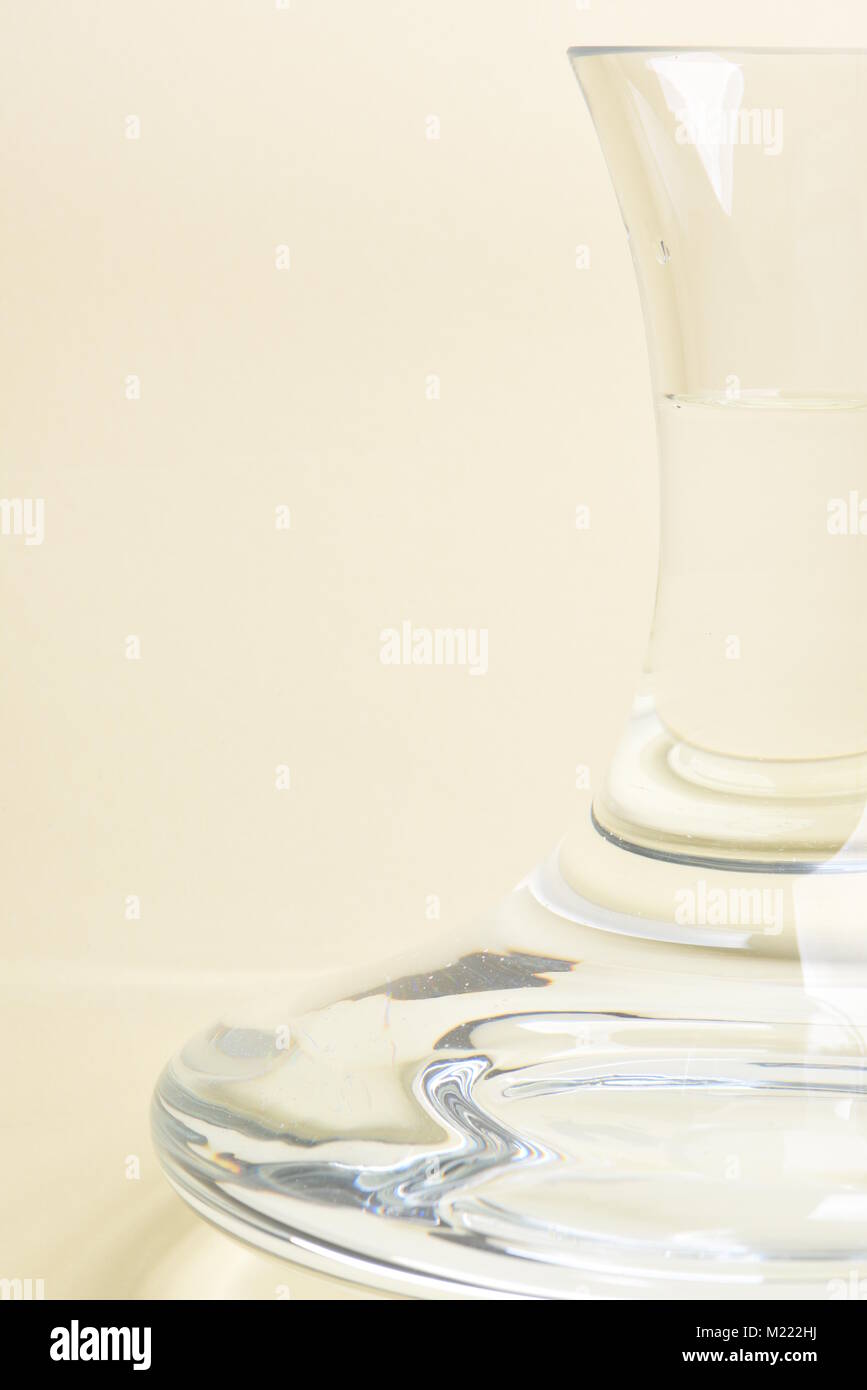 Glass carafe with water on beige background Stock Photo