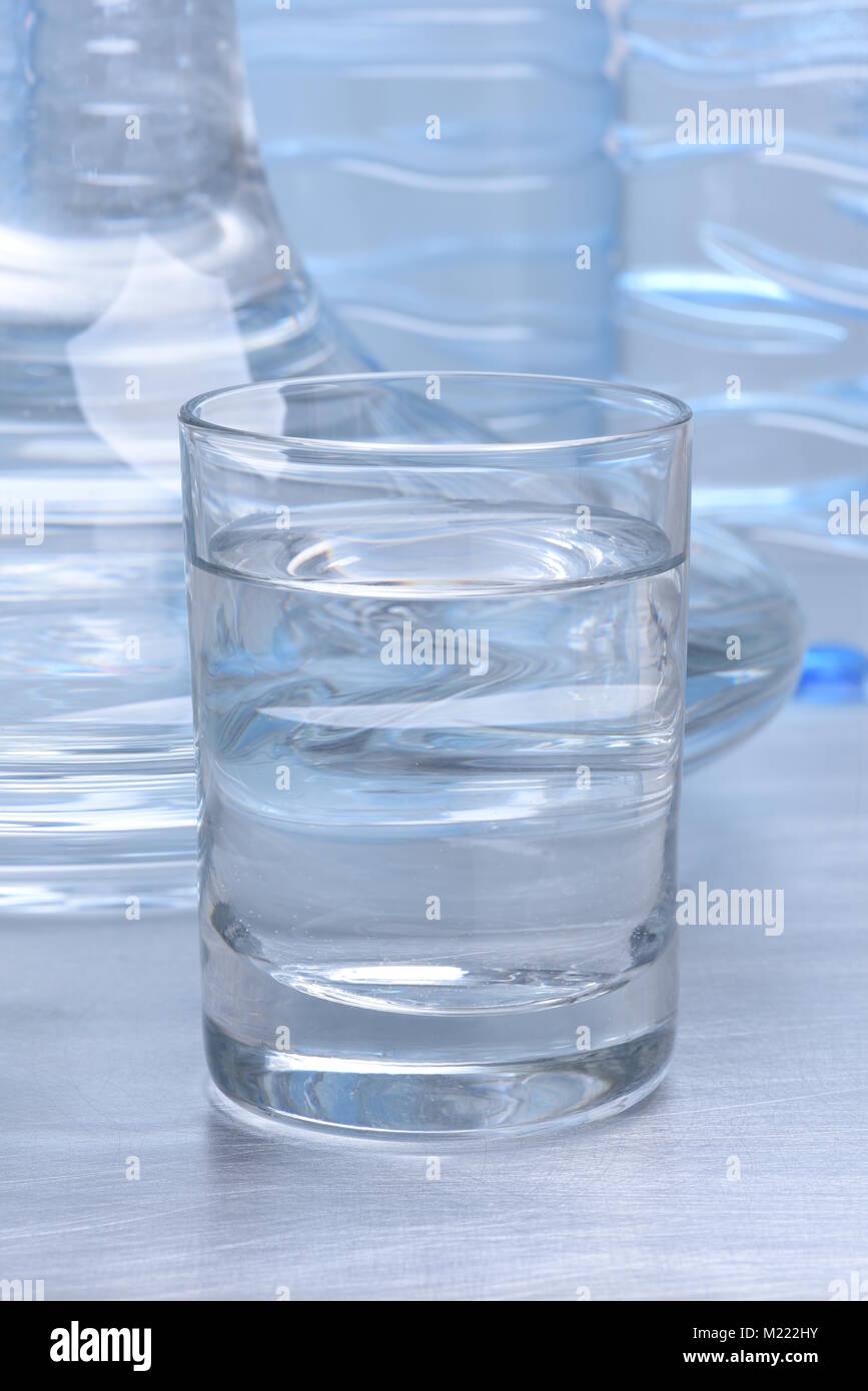 Glass and carafe with water on metal table Stock Photo