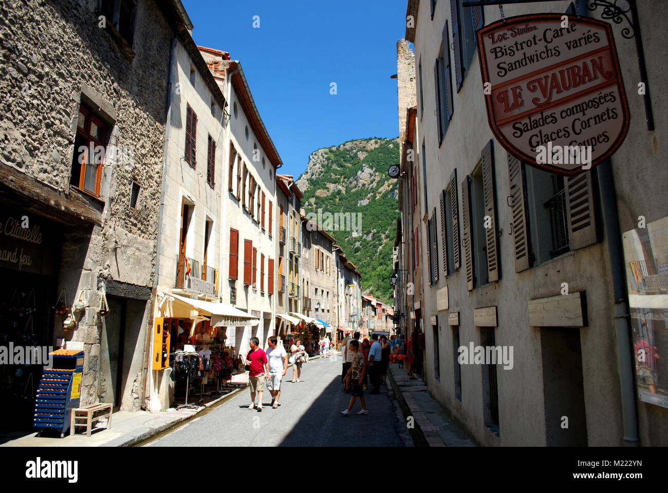 A pretty street busy with tourists in the pretty walled town of Villfranche de Conflent in the south of France. This medieval city dates back to the 1 Stock Photo