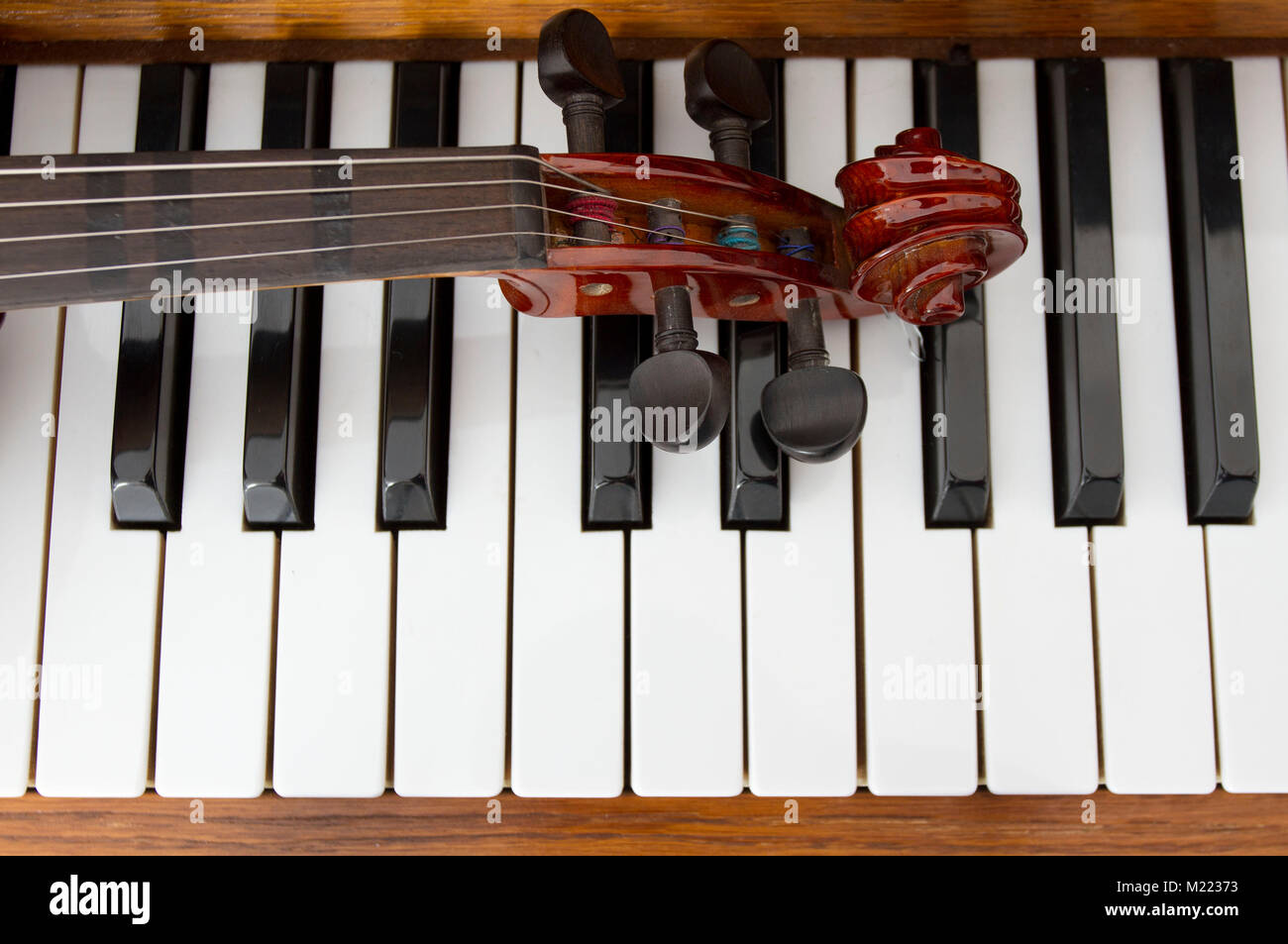 Classical violin on wooden piano keys. Classical violin on piano for