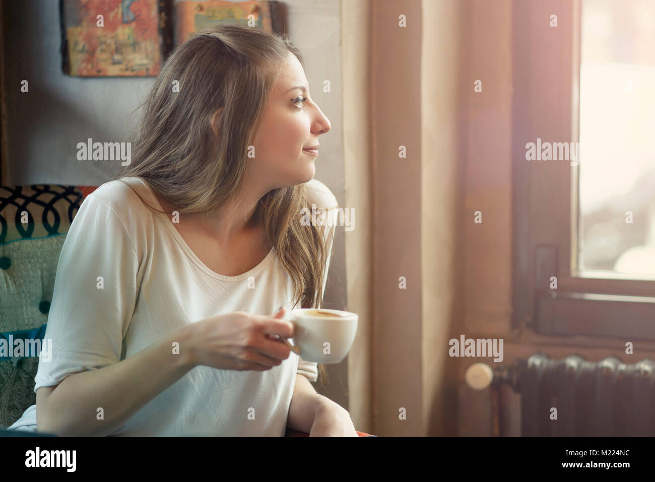 Happy young woman in a coffee shop Stock Photo - Alamy
