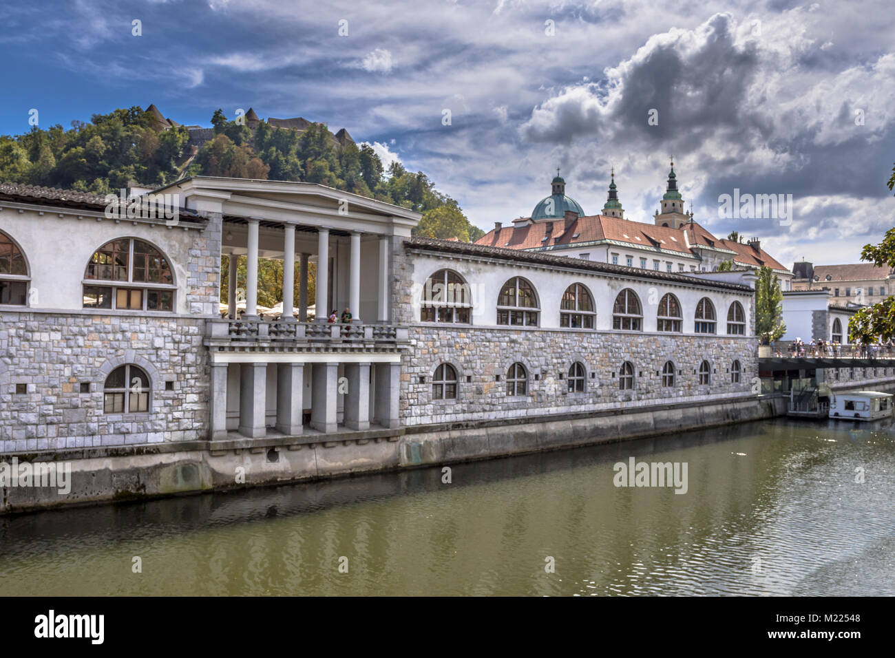 LJUBLJANA, SLOVENIA, AUGUST 11 2017: Cityscape view on Ljubljanica river canal and university in Ljubljana old town Stock Photo