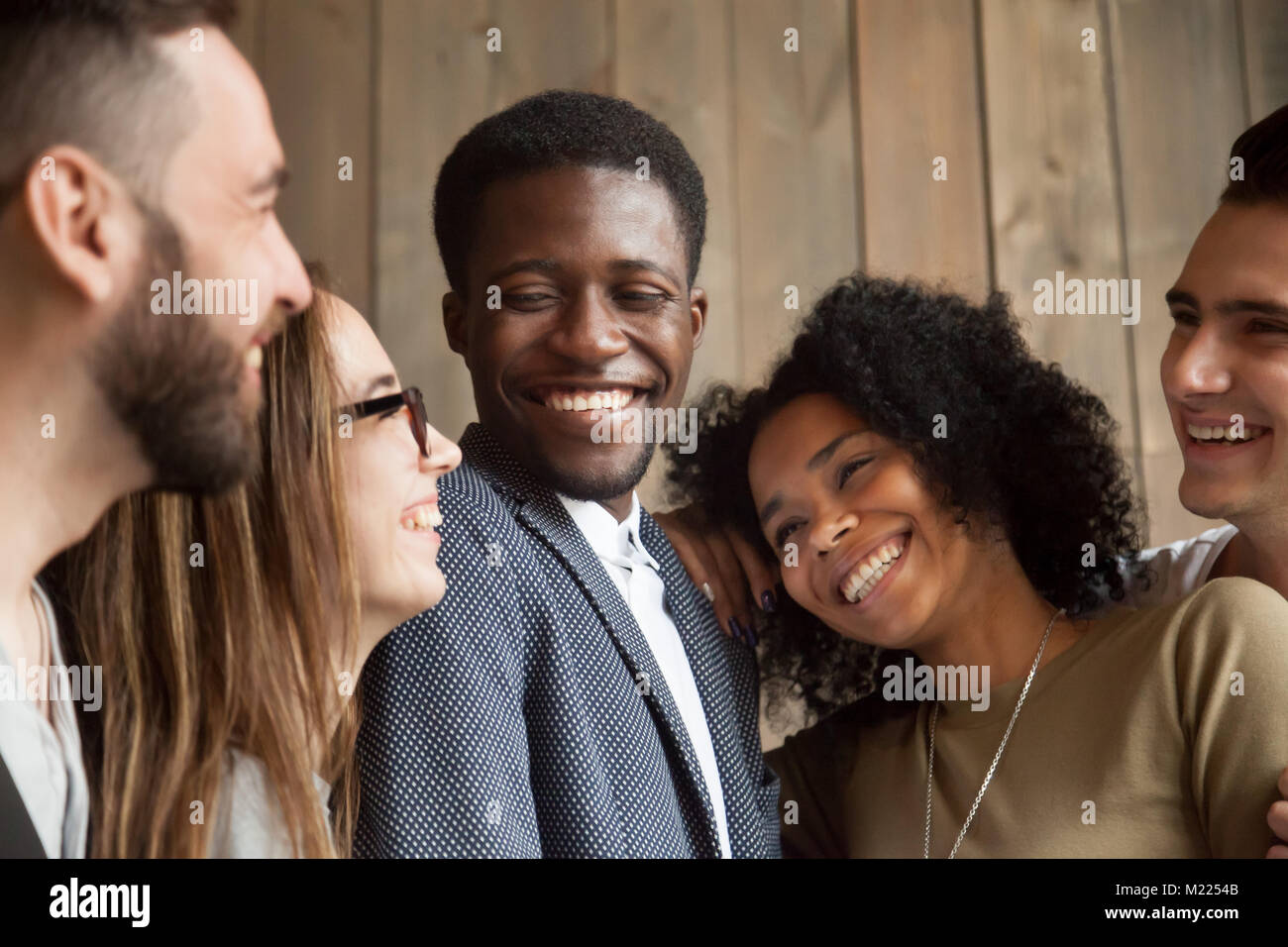 Happy diverse black and white people group smiling bonding toget Stock Photo