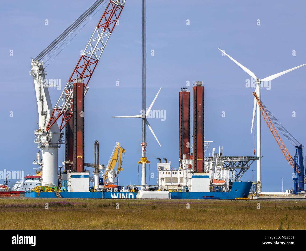 Offshore wind turbine supply vessel anchored and loading in port of Eemshaven, Netherlands Stock Photo
