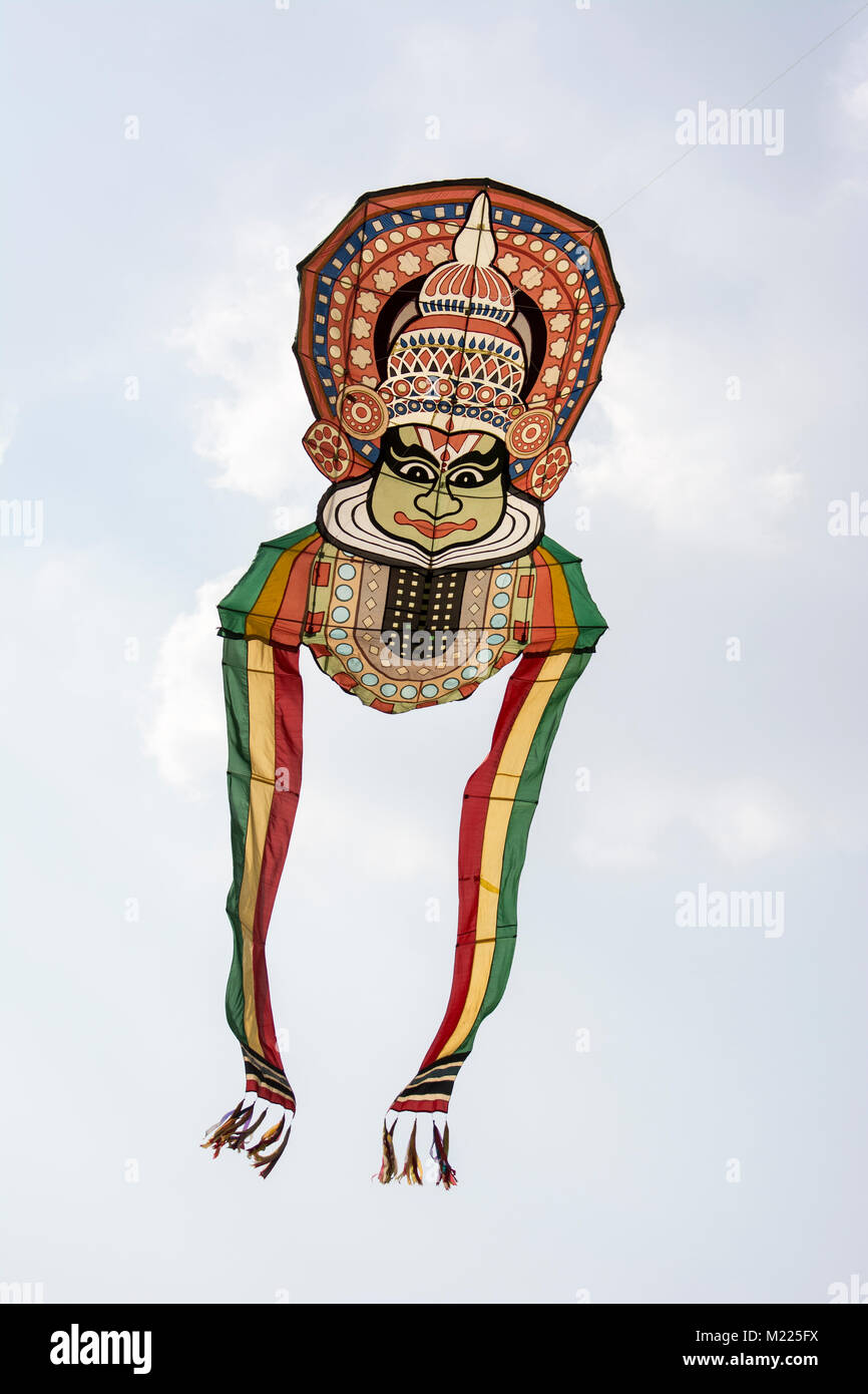 A kite showing an artistic mask on a human face at International Kite Festival Stock Photo