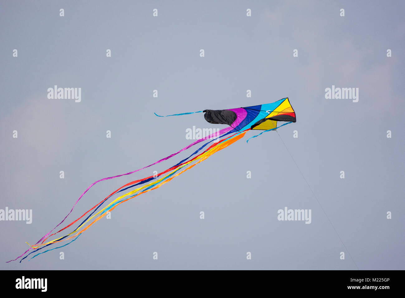 Rainbow colored kite with a long tail at International Kite Festival ...