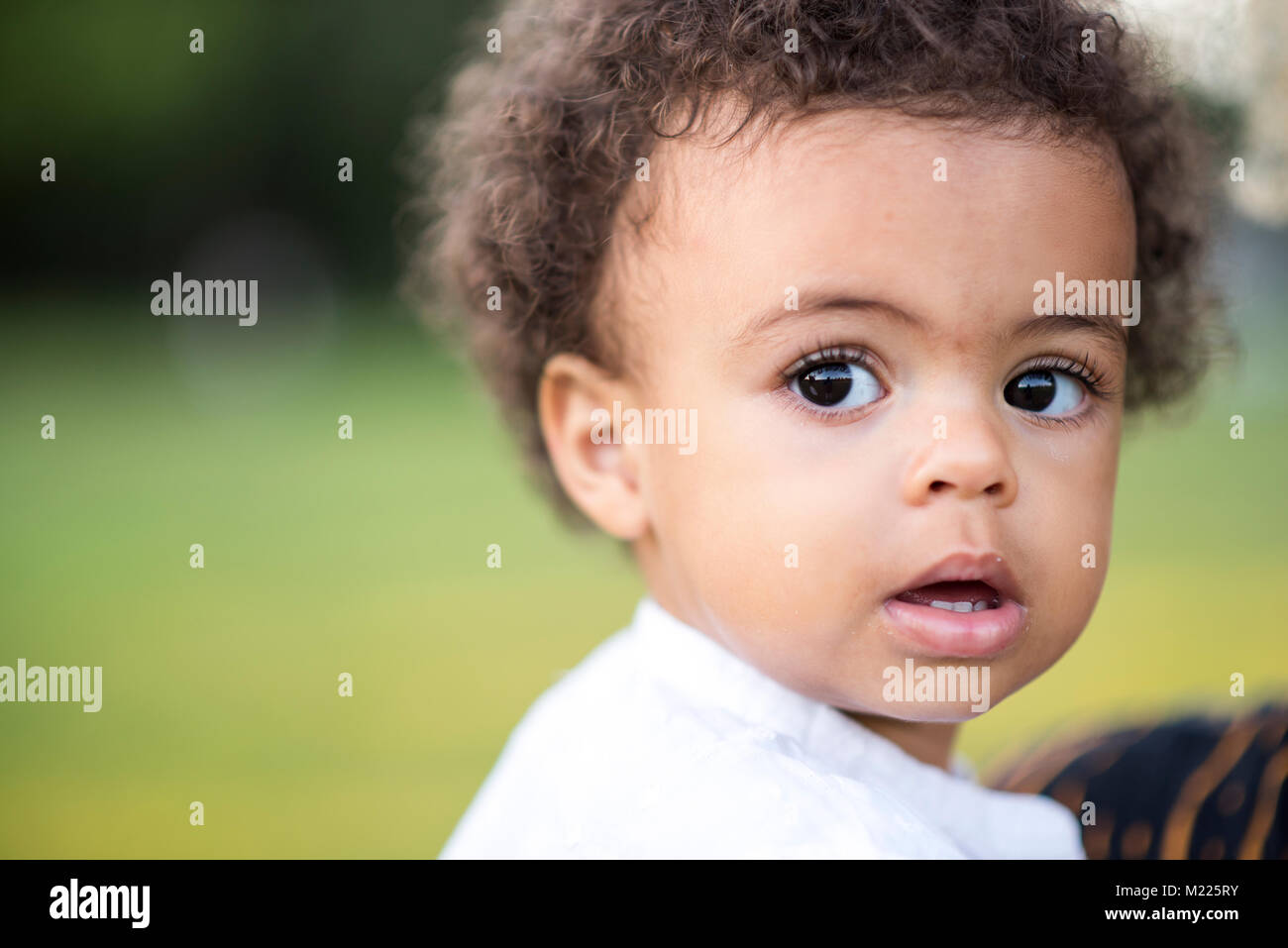 Mixed Race Baby Boy With Blue Eyes Looking At Camera Stock Photo Alamy