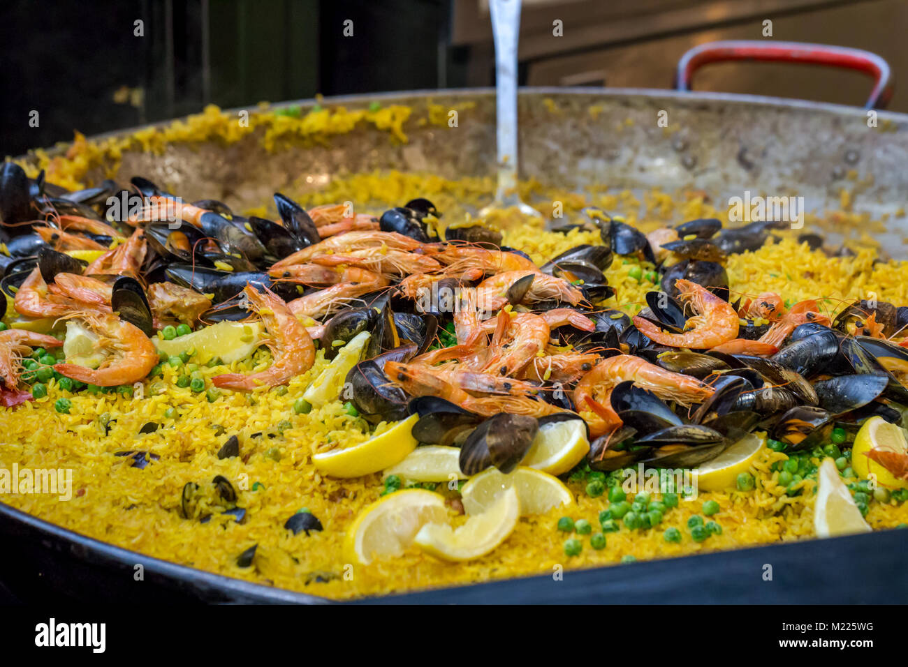 A large pan of seafood paella being cooked in Borough Market, London Stock Photo