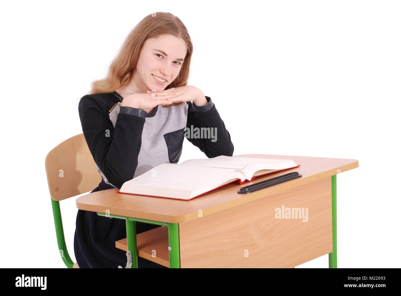 School girl sitting at a desk isolated on white Stock Photo - Alamy