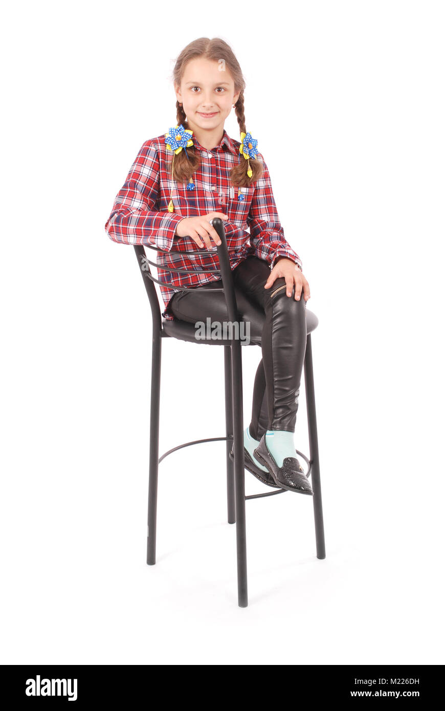 Portrait of adorable smiling little girl sitting on a chair with her ...
