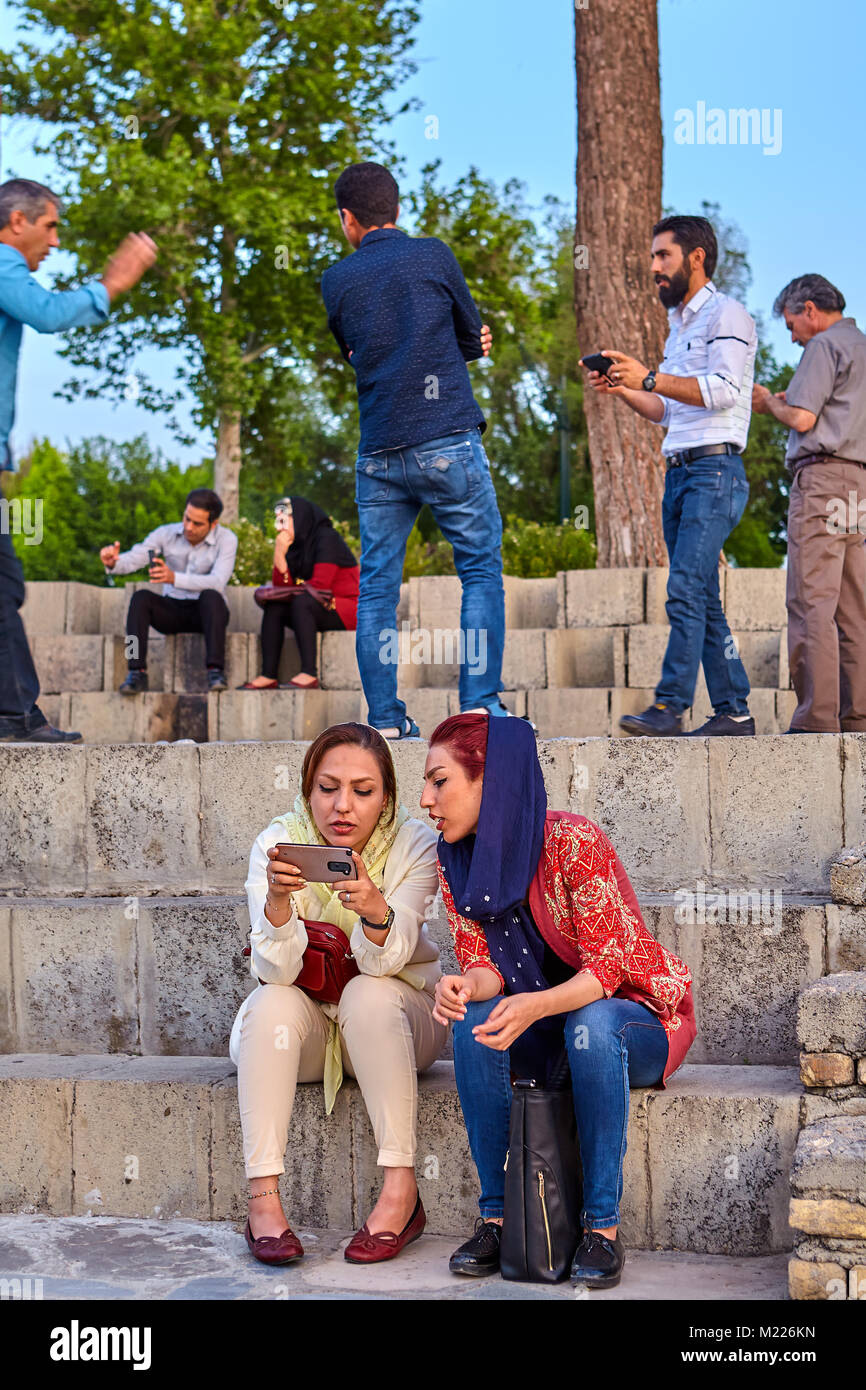 Isfahan, Iran - April 24, 2017: Two modern Iranian girls, dressed in a  mandatory hijab, view the images on the screen of a mobile device Stock  Photo - Alamy